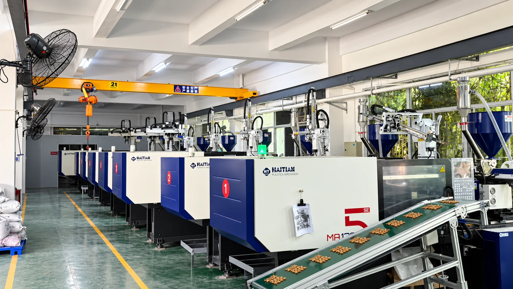 Haitian injection molding machines and conveyor inside Taisheng's production workshop